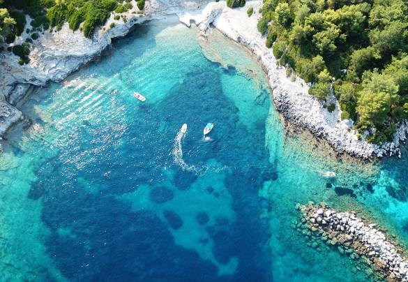 Aerial view of clear blue waters on the coast in Greece.